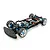 A high-angle studio shot of a Tamiya TB-05R 1/10 scale RC touring car chassis, featuring blue anodized aluminum parts, carbon fiber shock towers, and foam bumper.