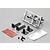 Killerbody 1/10 scale RC exhaust pipe set including chrome exhaust tips on a sprue, mounting brackets, screws, adhesive tape, and heat shield material.