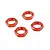 Four orange anodized aluminium serrated wheel nuts for RC cars arranged on a white background.