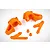 A set of bright orange nylon RC steering components including two steering hubs, two steering arms, and two small bushings on a white background.