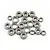 A collection of twenty metal ball bearings of varying sizes scattered on a white background.
