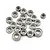 A collection of twenty small metal ball bearings of various sizes scattered on a white background.