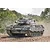 A Leopard 1 A5 tank in camouflage paint driving through a dusty, wooded landscape.