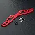 A red anodized aluminium bumper brace for an RC car, accompanied by two black countersunk screws and a small MST brand sticker on a dark textured surface.