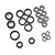 A collection of various sized metal ball bearings with black rubber seals arranged on a white background.