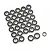 A collection of numerous small metal ball bearings with black rubber seals arranged on a white background.