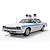 A 1/32 scale Scalextric Dodge Monaco Chicago Police slot car from The Blues Brothers, featuring a white body, blue stripes, and roof-mounted sirens.