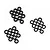 A collection of small black aluminium flat washers arranged in three groups on a white background.