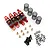 A set of four red aluminium RC shock absorbers with black springs, brass spacers, screws, and O-rings on a white background.