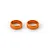 Two orange anodized aluminium steering arm shims for RC cars, shown against a plain white background.