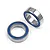 Two metal ball bearings with blue rubber seals on a plain white background.