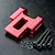 A red anodized aluminium rear upper deck connector for an RC car, accompanied by four black hex screws and four small washers on a black textured surface.