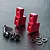 Two red anodized aluminium servo mounts with a set of black screws and washers on a textured black surface.