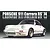 A studio shot of a white 1974 Porsche 911 Carrera RS model car against a dark background with reflective text above.
