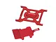 Two red anodized aluminium RC parts from GPM Racing, including a mounting plate with cutouts and a smaller battery hold-down bracket.