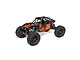 Axial UTB10 Capra 1.9 4WS RC rock crawler in orange and black with Fox branding, shown from a three-quarter angle on a white background.