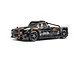 ARRMA Infraction 3S BLX RC truck in black and brown livery with street tires on a white background.
