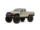 Axial SCX10 III Base Camp 1/10 scale RC rock crawler in grey, featuring a pickup truck body, black off-road wheels, and aggressive tread tires.