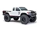 Side profile of a white Axial SCX24 Base Camp RC rock crawler truck with black wheels and off-road tires on a white background.