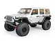 A silver Axial SCX6 Jeep JLU Wrangler 1/6 scale RC rock crawler viewed from the front three-quarter angle against a white background.