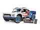 ARRMA Mojave Grom 1/16 scale RC short course truck in white, red, and blue livery, shown with its included LiPo battery and USB charger.