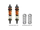 Two GPM Racing orange aluminium adjustable front RC shocks with gold springs, alongside two additional black replacement springs on a white background.