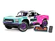 ARRMA Mojave Grom 1/16 scale RC short course truck in teal and pink livery with a Spektrum Smart battery and charger on a white background.