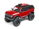 A red Axial SCX24 2021 Ford Bronco RC rock crawler viewed from a high angle against a white background.