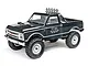 A black 1/24 scale Axial SCX24 1967 Chevrolet C10 RC rock crawler truck viewed from a front three-quarter angle on a white background.