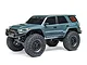 Axial SCX24 Toyota 4Runner RC rock crawler in grey, featuring large off-road tires, black wheels, and detailed decals on a white background.