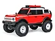 A studio shot of the Axial SCX24 2021 Ford Bronco Heritage RC rock crawler in red and white, featuring white wheels and off-road tires.