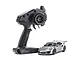 A Kyosho Mini-Z MR-04 Porsche 911 GT3 RS RC car in metallic silver next to its black KT-531P pistol-grip transmitter.