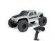 Axial SCX10 III Coyote RC rock crawler in silver with black hood and off-road tires, shown with a Spektrum SLT2 radio transmitter.