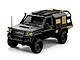 A black MN Model Toyota LC79 RC rock crawler truck with tan accents, roof rack, and snorkel, viewed from a front three-quarter angle on a white background.