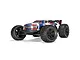 ARRMA Kraton 6S V6 BLX RC Truggy in blue, white, and red livery, viewed from a low front-three-quarter angle against a white background.