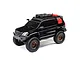 A black Axial SCX24 Lexus GX 470 RC rock crawler with off-road accessories on the roof rack, shown against a white background.