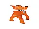 An orange GPM Racing aluminium RC car and truck work stand against a white background.