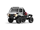 A silver MN Model Unimog RC rock crawler truck with black roll cage, off-road tires, and illuminated headlights on a white background.