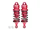 Two red GPM Racing aluminium adjustable RC shock absorbers with black springs and two small white plastic pivot balls on a white background.