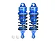 Two blue GPM Racing aluminium adjustable RC shock absorbers with black springs and two small white plastic ball joint inserts on a white background.