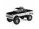 Axial SCX24 1/24 scale RC rock crawler featuring a black and white Chevrolet C10 truck body with a chrome roll bar and off-road lights.