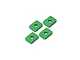Four small, rectangular green anodized aluminium spacers with a central hole, arranged on a white background.