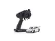 A white Kyosho Mini-Z Porsche 911 GT3 RS RC car next to a black Syncro KT-531P transmitter on a white background.