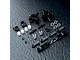 A set of MST black aluminium rear hubs and associated hardware including ball ends, turnbuckles, and spacers on a textured black surface.