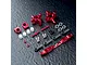 A set of red anodized aluminium RC rear hubs and associated hardware including turnbuckles, ball ends, and spacers on a dark textured surface.