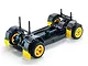 A 1/10 scale RC rally car chassis roller with yellow wheels, black mudflaps, and blue shock absorbers on a white background.