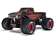 ARRMA Quake Grom 1/16 scale 4WD electric RC monster truck in red and black, studio shot on white background.
