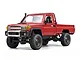 Studio shot of the MN Model Toyota LC79 1/12 scale RC rock crawler in red against a white background.