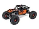 Axial UTB10 Capra 1/10 scale 4WS electric RC rock crawler in orange and black with Fox branding.