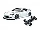 MST 86RB white RC drift car body with wide body kit alongside its black chassis on a white background